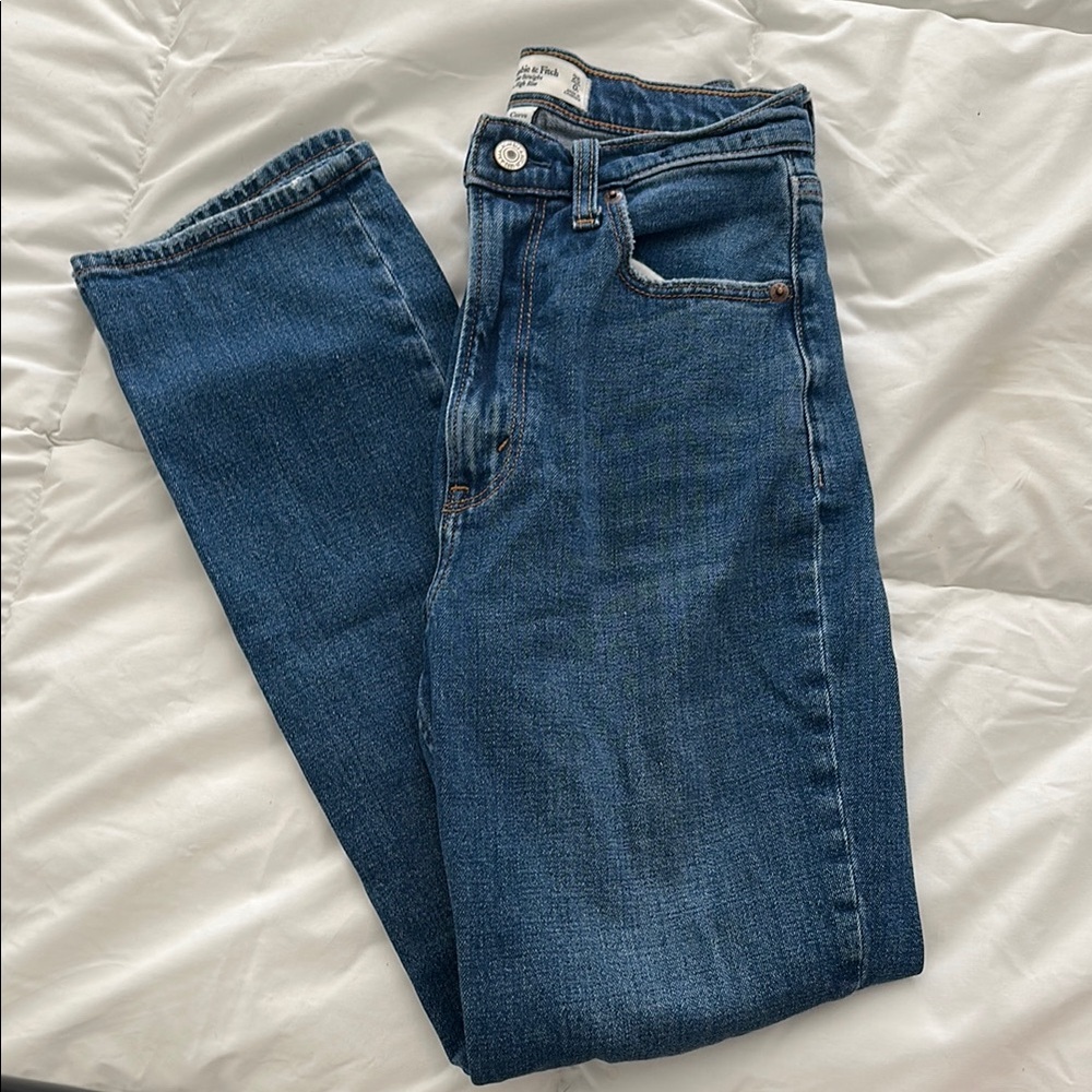 Women’s straight leg jeans with small holes on each knee super cute and comfy